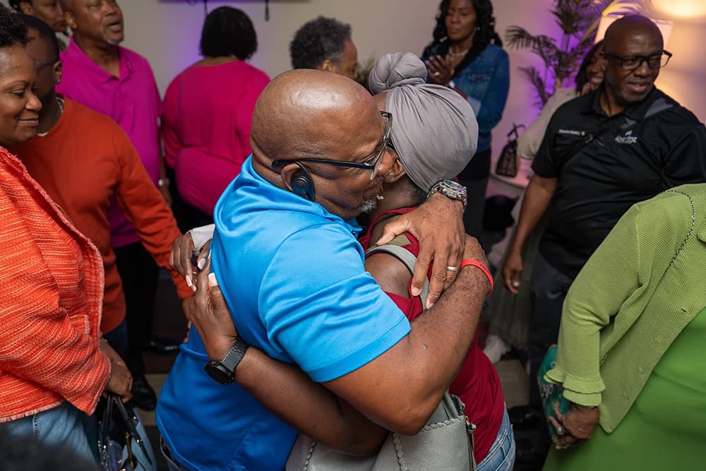 Love First Christian Center new members hugging each other